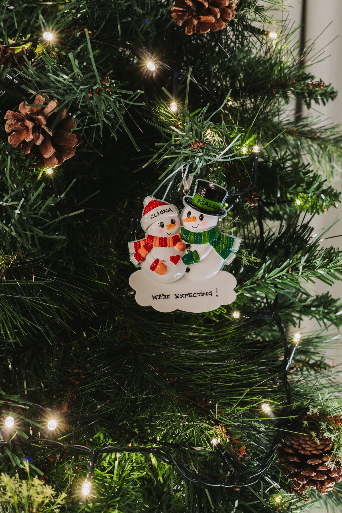 Expecting A Baby Personalised Christmas Decoration hanging on a Christmas tree