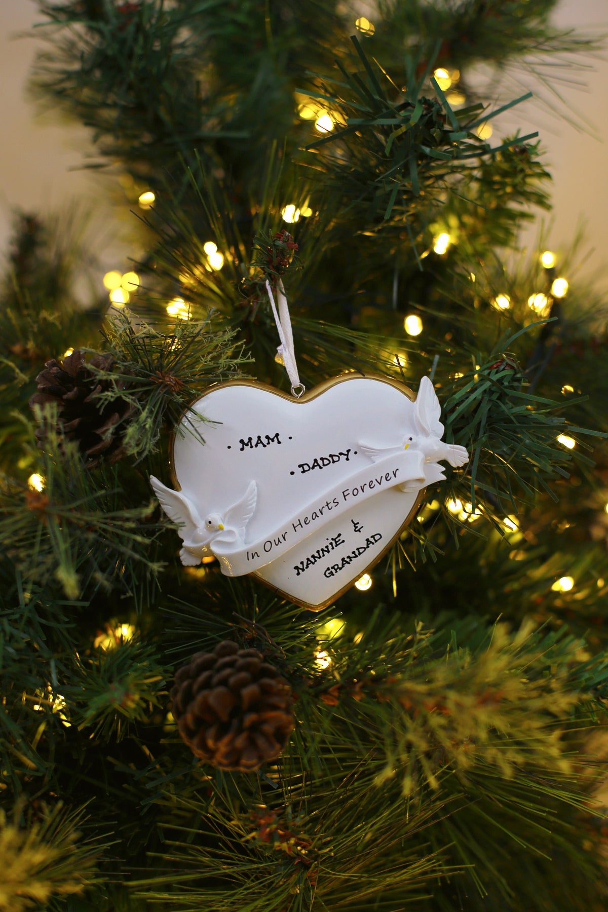 In Our Hearts Forever hanging on a Christmas tree