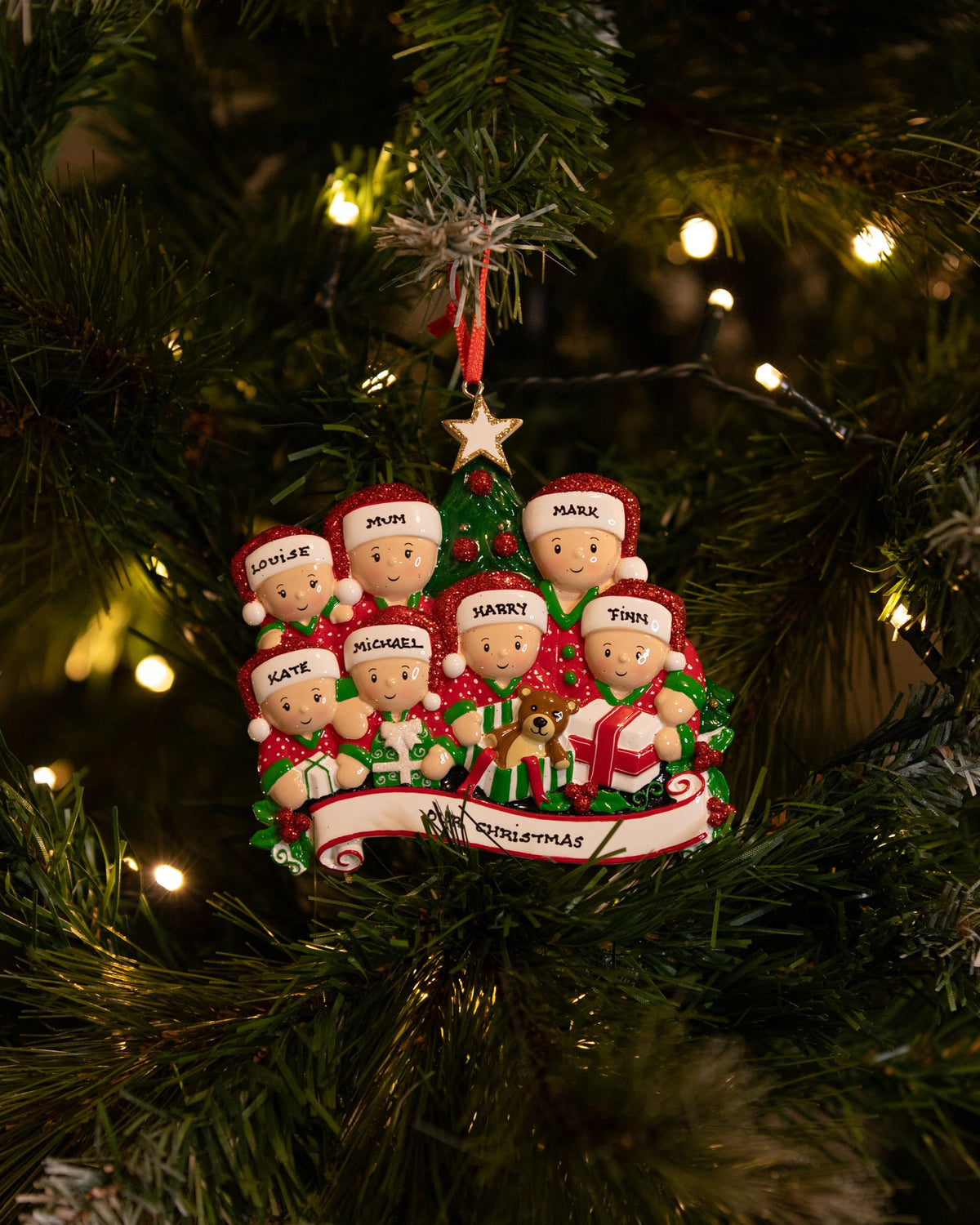 Opening Presents (Family of 7) Personalised Christmas Decoration hanging on a Christmas tree