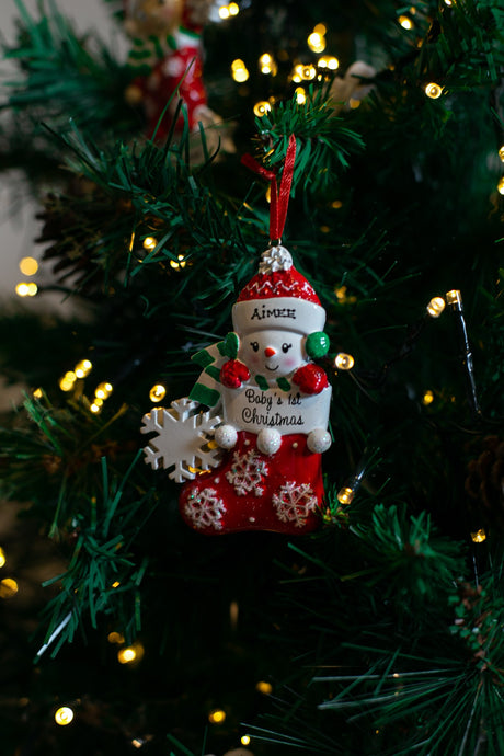 Baby Snowman in Stocking (Red) hanging on a Christmas tree