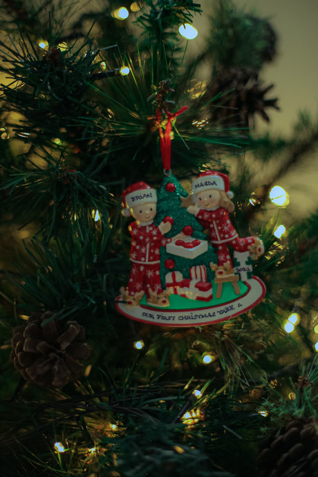 Couple at the Christmas Tree Personalised Christmas Decoration hanging on a Christmas tree