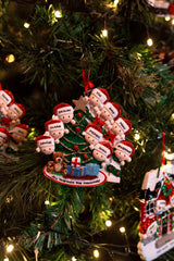Family Peeking over the Bannisters for a family of 9 Personalised Christmas Decoration hanging on a Christmas tree