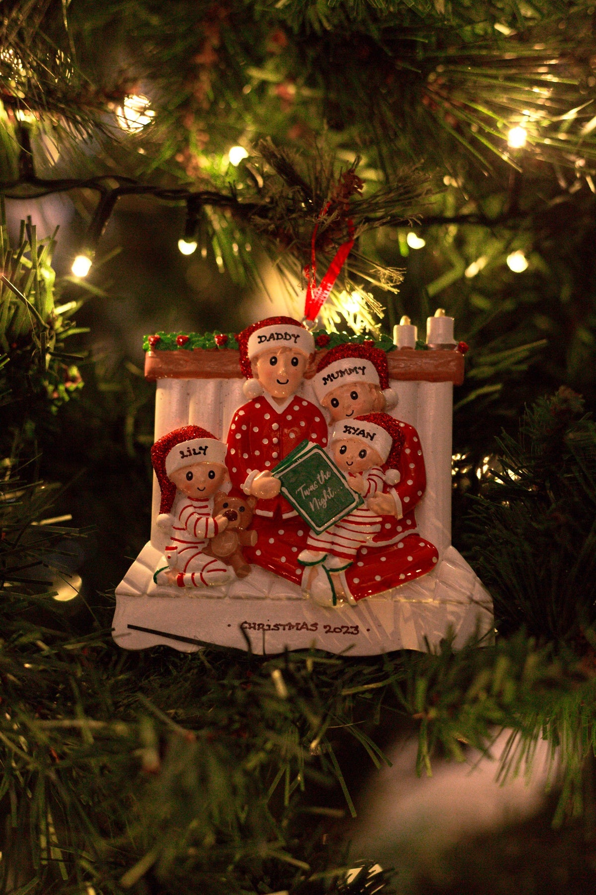 Family Reading in a bed x 4 Personalised Christmas Decoration hanging on a Christmas tree