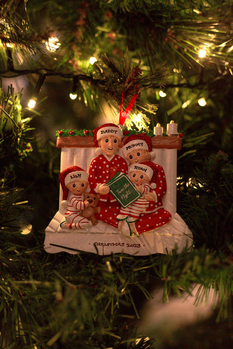 Family Reading in a bed x 4 Personalised Christmas Decoration hanging on a Christmas tree