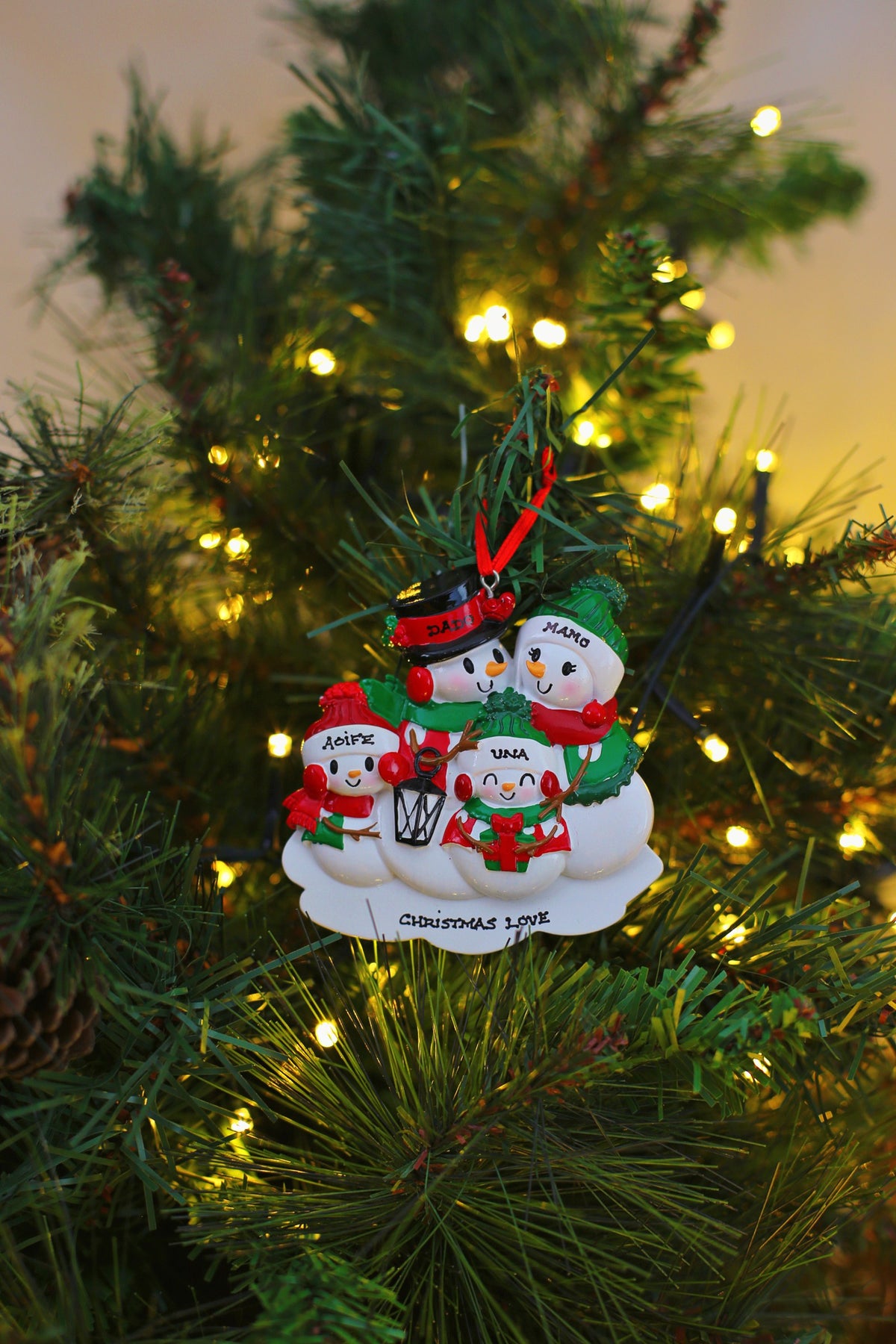 New Snowman Family of 4 Personalised Christmas Decoration hanging on a Christmas tree