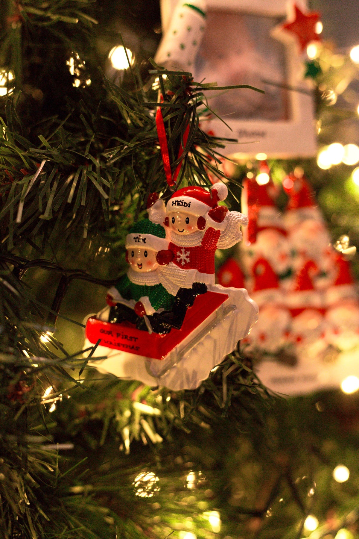 People Sled Family x 2 Personalised Christmas Decoration hanging on a Christmas tree