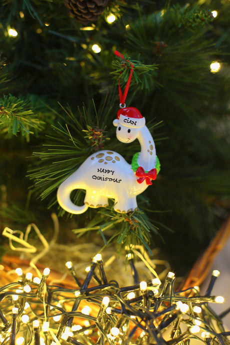 White Dino with Wreath Personalised Christmas Decoration hanging on a Christmas tree