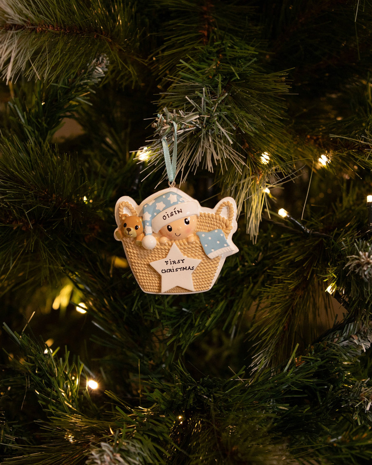 Baby in Basket (Blue) Personalised Christmas Decoration hanging on a Christmas tree