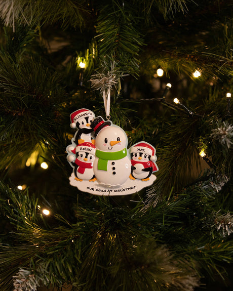 Family Building a Snowman (Family of 3) Personalised Christmas Decoration hanging on a Christmas tree