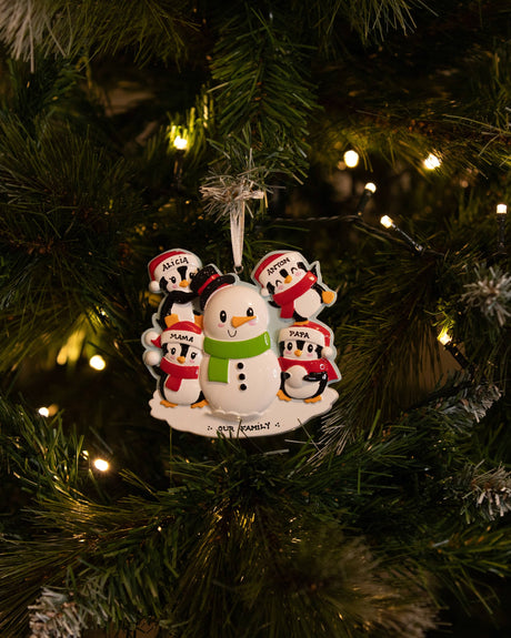 Family Building a Snowman (Family of 4) Personalised Christmas Decoration hanging on a Christmas tree