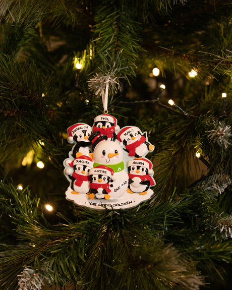 Family Building a Snowman (Family of 6) Personalised Christmas Decoration hanging on a Christmas tree