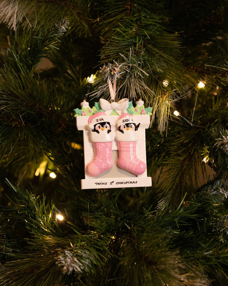 Twin Penguins in Stockings (Pink & Pink) Personalised Christmas Decoration hanging on a Christmas tree