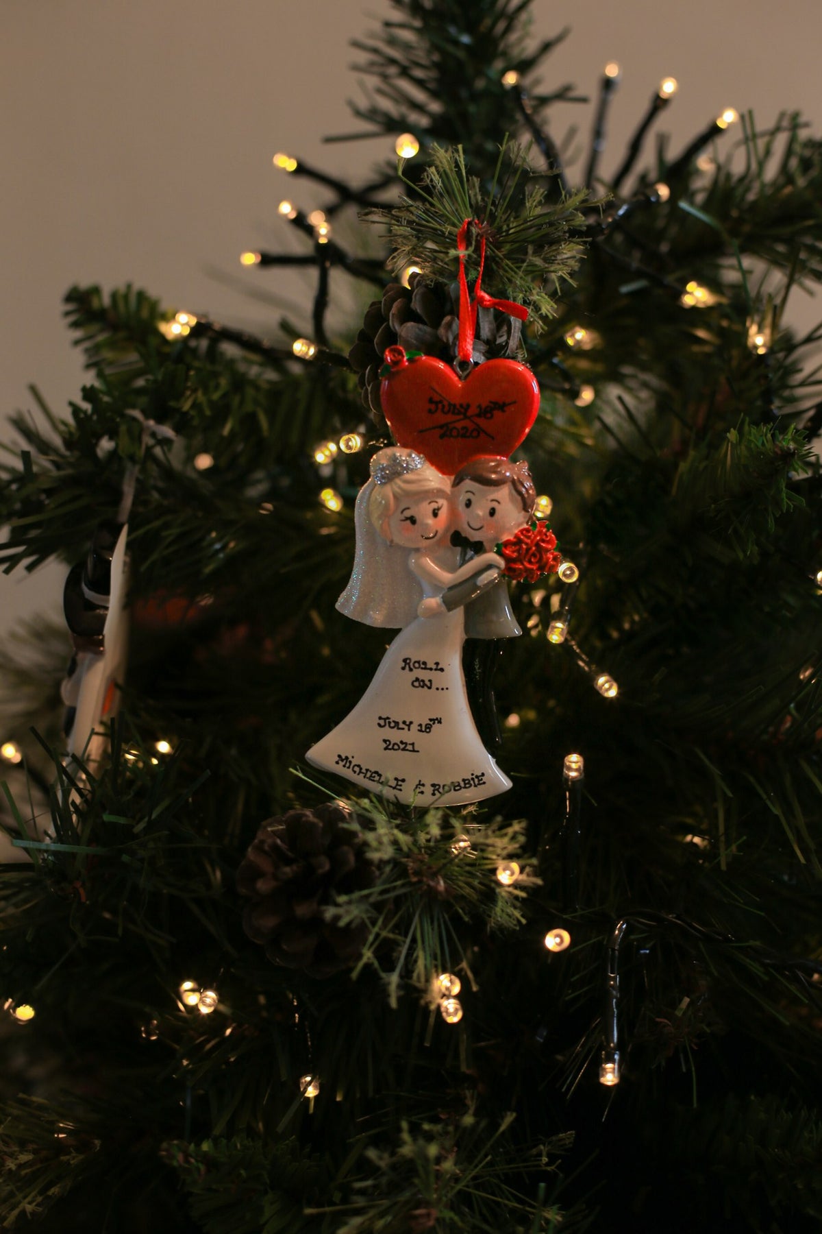 A Wedding Couple under Red Love Heart Personalised Christmas decoration hanging on a Christmas tree