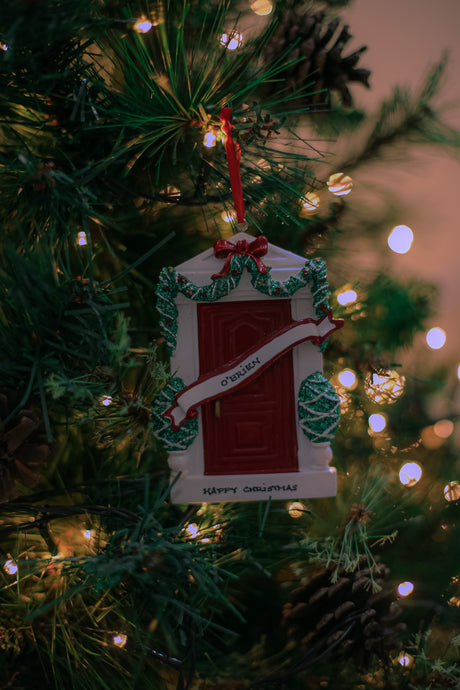 Red Door Personalised Christmas Decoration hanging on a Christmas tree