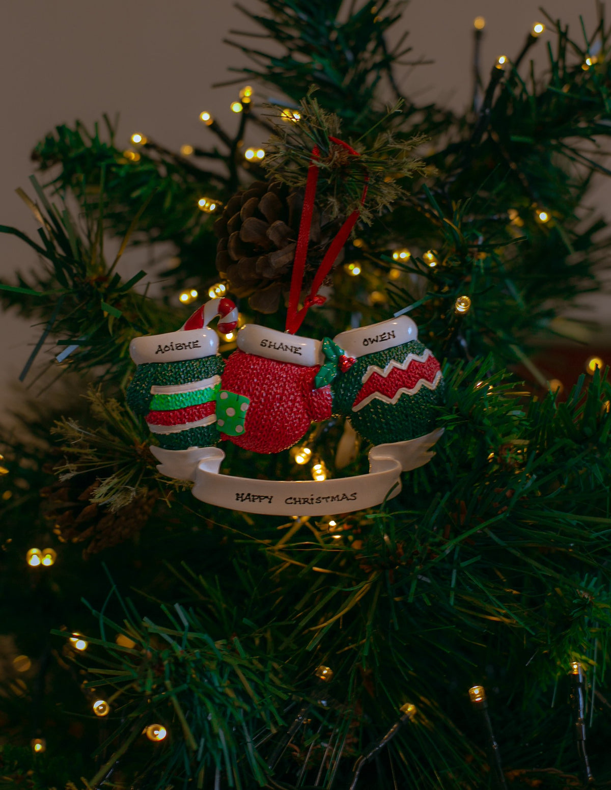 Christmas Mittens x 3 hanging on a Christmas tree