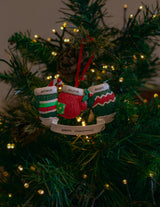 Christmas Mittens x 3 hanging on a Christmas tree
